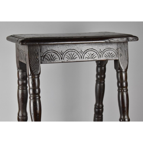 201 - An 18th Century Oak Peg Jointed Stool with Carved Seat Rail and Four Turned Supports, Top 45x25cms