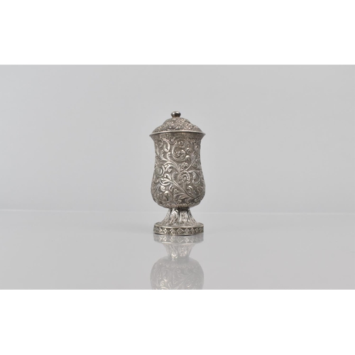 253 - A Late 19th Century Indian Silver Pepper Pot with Scrolled Foliate Decoration. 8.5cms High