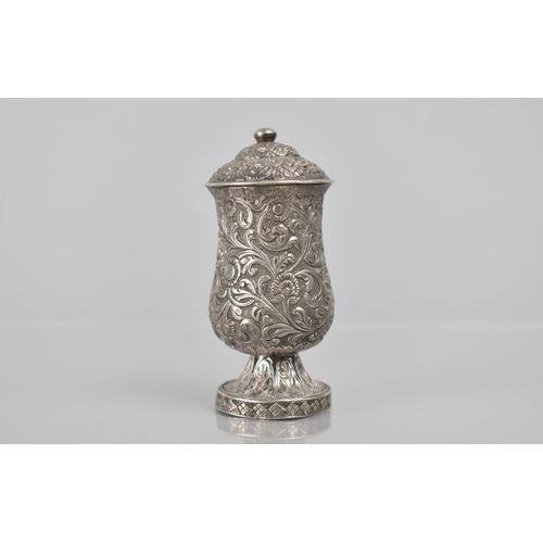 253 - A Late 19th Century Indian Silver Pepper Pot with Scrolled Foliate Decoration. 8.5cms High