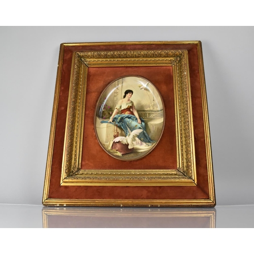 474 - A Continental Cushion Framed Oval Enamel Plaque in the Vienna Style depicting Seated Maiden with Coc... 