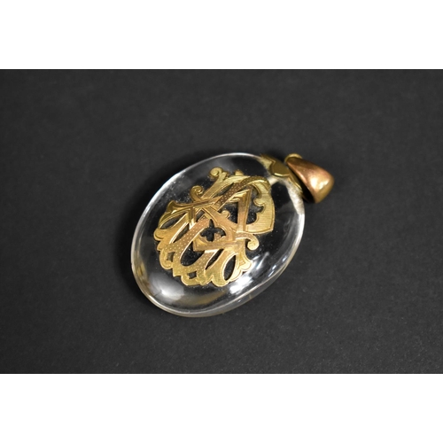 308 - A Large Victorian Glass and Yellow Metal Pendant of Oval Form with Monogram Mount, 5.5cms High