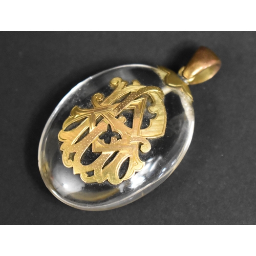 308 - A Large Victorian Glass and Yellow Metal Pendant of Oval Form with Monogram Mount, 5.5cms High