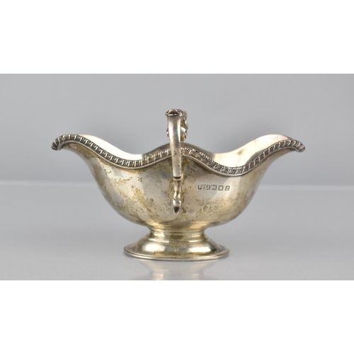 221 - A Victorian Silver Two Handled and Lipped Sauce Boat by Finnigans Ltd, London, Hallmark 1860, 180gms