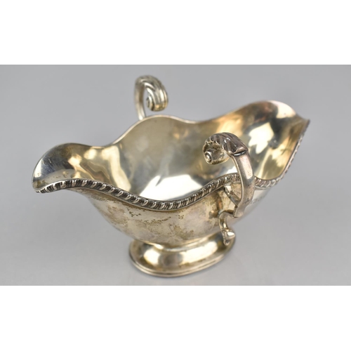 221 - A Victorian Silver Two Handled and Lipped Sauce Boat by Finnigans Ltd, London, Hallmark 1860, 180gms