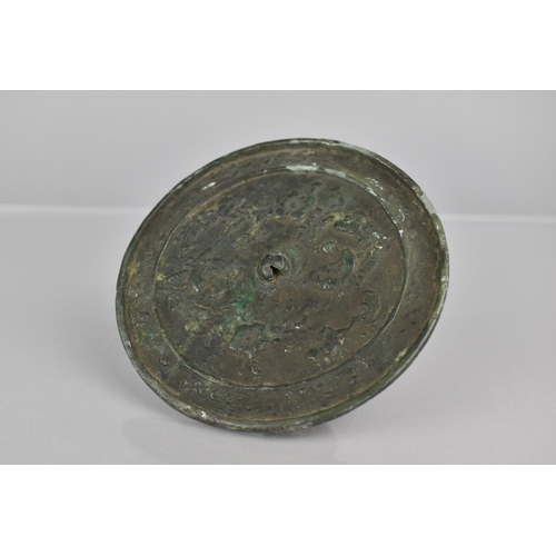 445 - Am 18th Century Chinese Bronze Mirror Decorated in a Floral Motif, 10cms Diameter