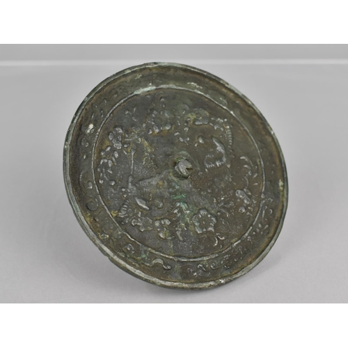 445 - Am 18th Century Chinese Bronze Mirror Decorated in a Floral Motif, 10cms Diameter