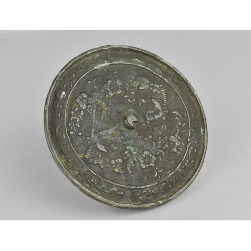 445 - Am 18th Century Chinese Bronze Mirror Decorated in a Floral Motif, 10cms Diameter