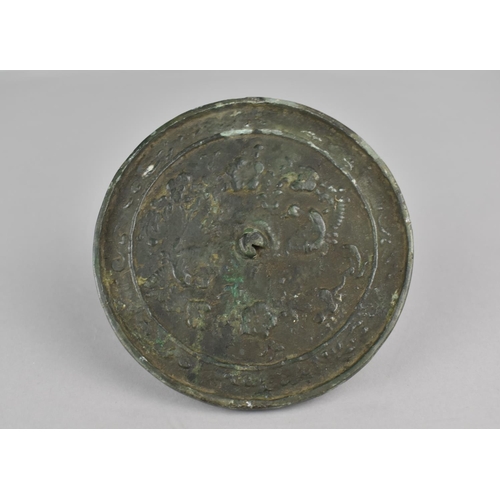 445 - Am 18th Century Chinese Bronze Mirror Decorated in a Floral Motif, 10cms Diameter