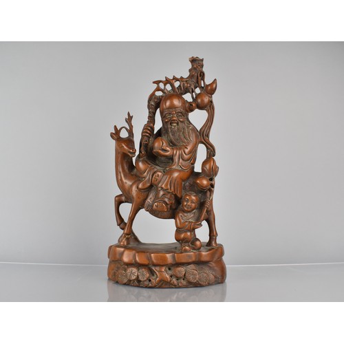 424 - A Chinese Root Carving Depicting Shou with Staff and Peach Riding Stag with Attendant to side, 34cm ... 