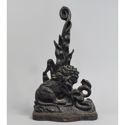 10 - A 19th Century Black Painted Cast Iron Door Porter Depicting Lion and Snake, 37cms High