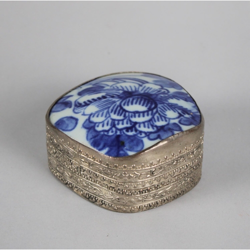 18 - A Far Eastern White Metal Bowl with Blue and White Glazed Ceramic Lid Depicting Flowers, 8.5cms Wide