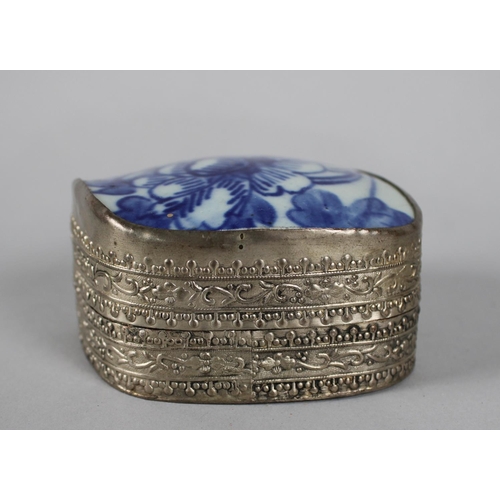 18 - A Far Eastern White Metal Bowl with Blue and White Glazed Ceramic Lid Depicting Flowers, 8.5cms Wide