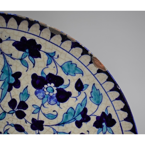 210 - A Glazed Charger Decorated in Blue Enamels in the Iznik Style 30cm Diameter