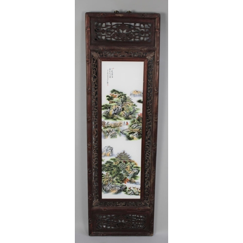 239 - A Chinese Wooden Framed Porcelain Panel, 120cms by 36cms