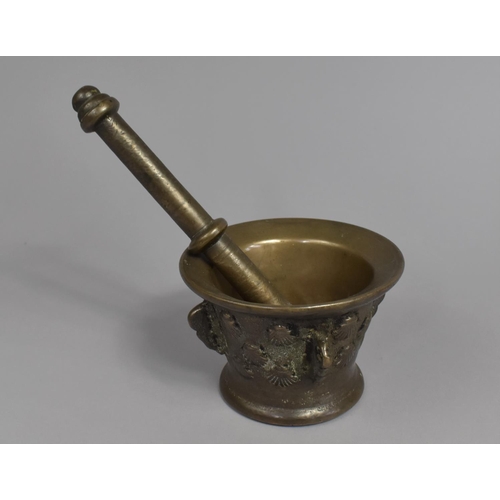 24 - A Late 17th/Early 18th Century Bronze Pestle and Mortar, Body Moulded with Seashells, 11.5cms Diamet... 