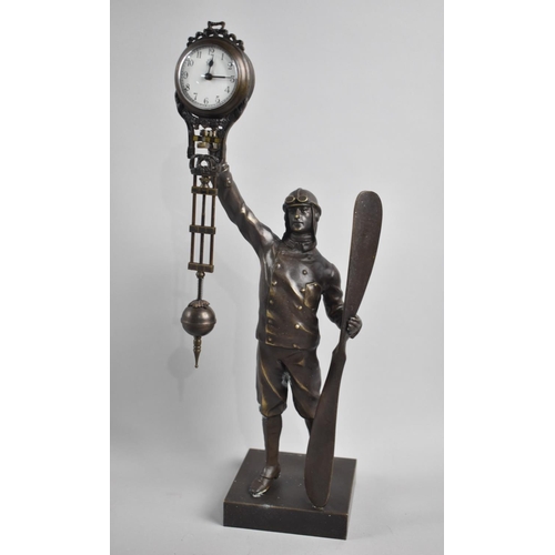 86 - A Novelty Bronze Figural Mystery Clock in the Form of a WWI Period Pilot holding Aircraft Propellor ... 