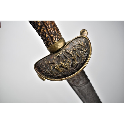 135 - A Late 19th Century Saw Back Hunting Sword with Kidney Shaped Brass Guard Decorated with Lyre, Antle... 