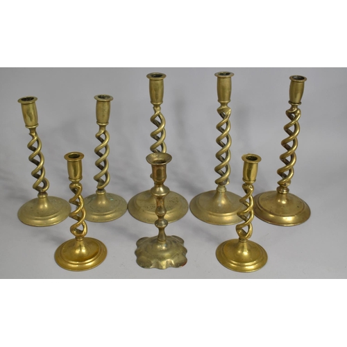 A Collection of Brass Barley Twist Candlesticks Together with a