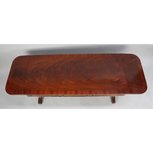 32 - A Reproduction Crossbanded Mahogany Drop Leaf Coffee Table in the Form of a Sofa Table with Single L... 