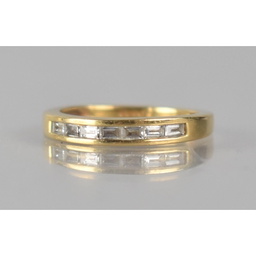 51 - An 18ct Gold and Diamond Dress Ring comprising Seven Channel Set Baguette Cut Diamonds, Each Approx ... 