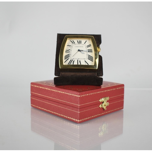 24 - A Cartier La Dona Travel Desk Clock. Shaped White Dial with Roman Numerals, Blue Diamond Shaped Hand... 