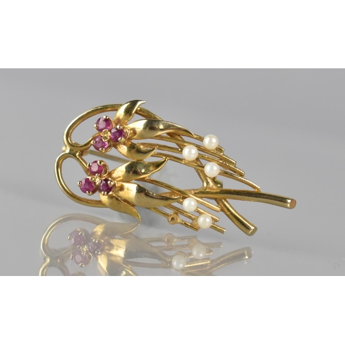 129 - A 9ct Gold, Ruby and Seed Pearl Brooch, Organic Stylised Floral Design having Two Three Stone Cluste... 