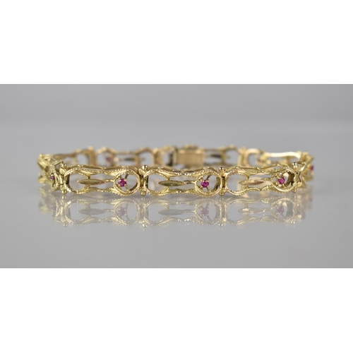 131 - A 14ct Gold and Ruby Nine Panel Wirework Bracelet, Pressed and Textured Figure of Eight Wire Frames,... 