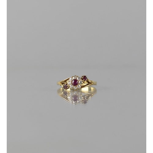 63 - An 18ct Gold, Diamond and Ruby Floral Cluster Ring, Centre Round Cut Ruby Measuring Approx 3mm Diame... 