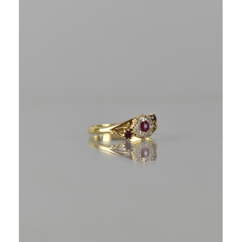 63 - An 18ct Gold, Diamond and Ruby Floral Cluster Ring, Centre Round Cut Ruby Measuring Approx 3mm Diame... 