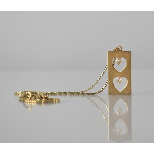 132 - A 9ct Gold and Diamond Pendant on a 9ct Gold Box Chain, Two Pierced Hearts Surmounted by Two Illusio... 