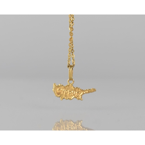 134 - An 18ct Gold Pendant on Chain, 'Cyprus', 18mm Wide, Mounted on a Trace Chain, 52cms Long Approx, Tot... 