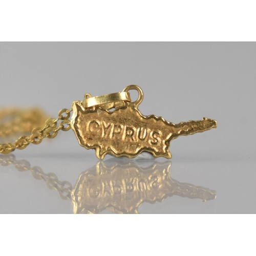 134 - An 18ct Gold Pendant on Chain, 'Cyprus', 18mm Wide, Mounted on a Trace Chain, 52cms Long Approx, Tot... 