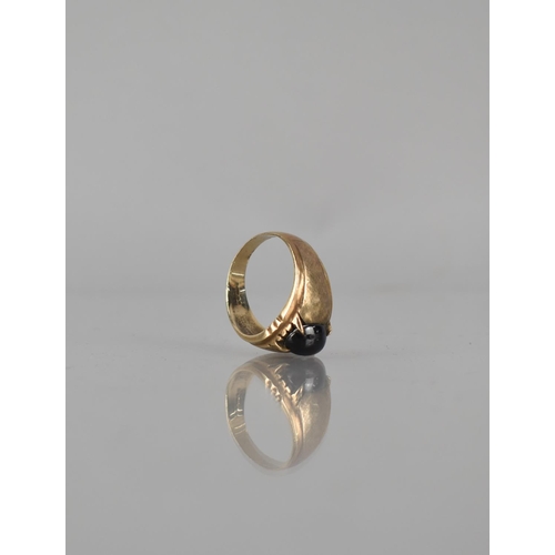 26 - A 9ct Gold and Garnet Ring, Centre Stone Measuring 10mm by 7.5mm Approx, Four Claw Setting to Textur... 