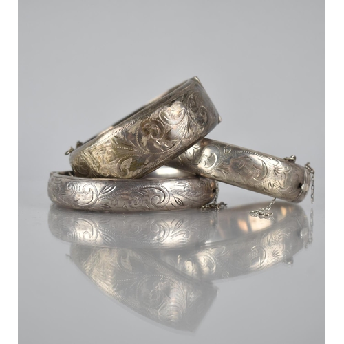 322 - A Collection of Three Vintage Silver Hinged Bangles, all with Engraved Foliate Decoration, 76gms