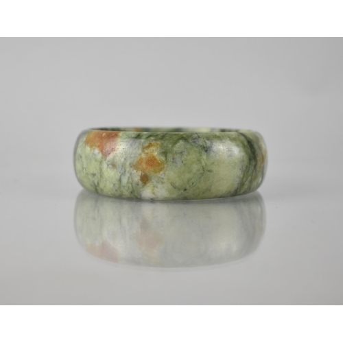 197 - A Large Green Stone Jade Carved Bangle, 25mm Wide and 69mm Internal Dimensions, 102.8gms