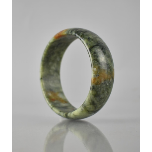 197 - A Large Green Stone Jade Carved Bangle, 25mm Wide and 69mm Internal Dimensions, 102.8gms