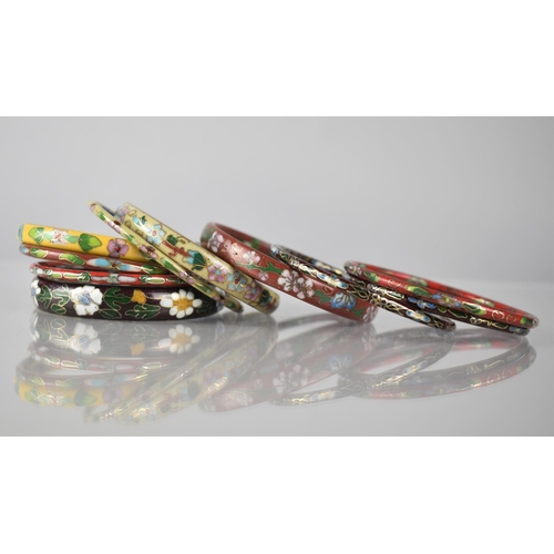 203 - A Collection of Eleven Various Red, Cream and Yellow Enamelled Cloisonne Bangles