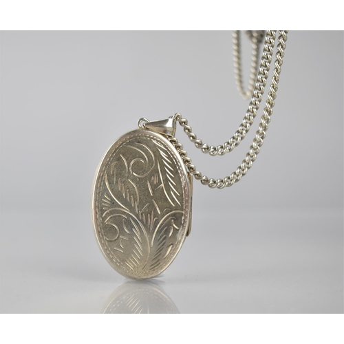 301 - A Large Silver Photo Locket on Chain, Locket with Engraved Swirling Decoration and Measuring 45x30mm... 