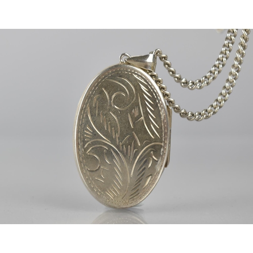 301 - A Large Silver Photo Locket on Chain, Locket with Engraved Swirling Decoration and Measuring 45x30mm... 