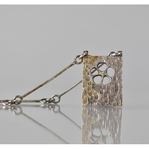 226 - A Mid Century Silver Rectangular Pendant and Chain, Hand Hammered and Fret Cut with Five Petal Flora... 