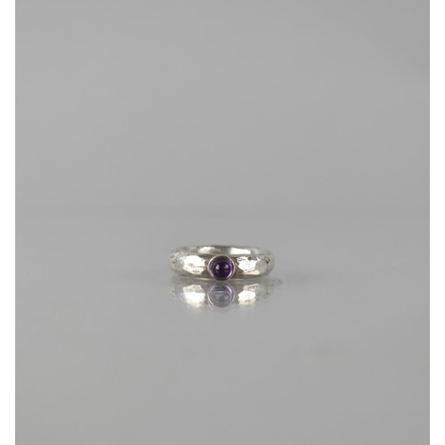 317 - A Silver and Amethyst Ring, Cabochon Amethyst 3.5mm Diameter, in Collet Setting to a Heavy Hand Hamm... 