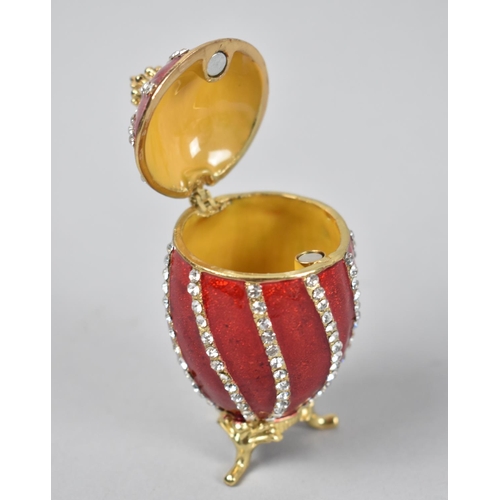 8 - A Novelty Jewelled and Enamel Box in the Form of a Russian Egg on Tripod Scrolled Feet, 7.5cms High