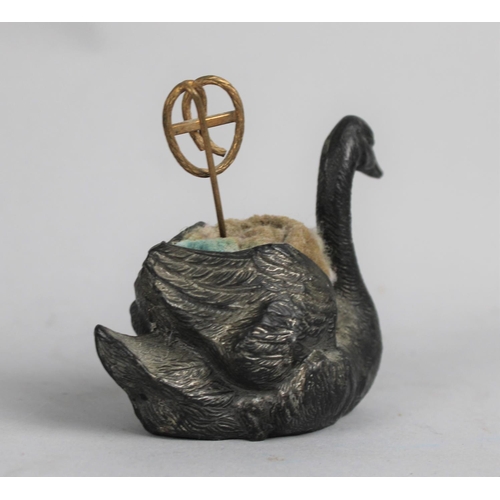 24 - A Novelty Spelter Pin Cushion in the Form of a Swan having Staffordshire Knot Pin