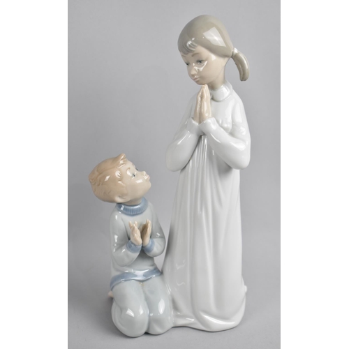 250 - A Lladro Figure of Girl and Boy Saying Prayers, 22.5cms High