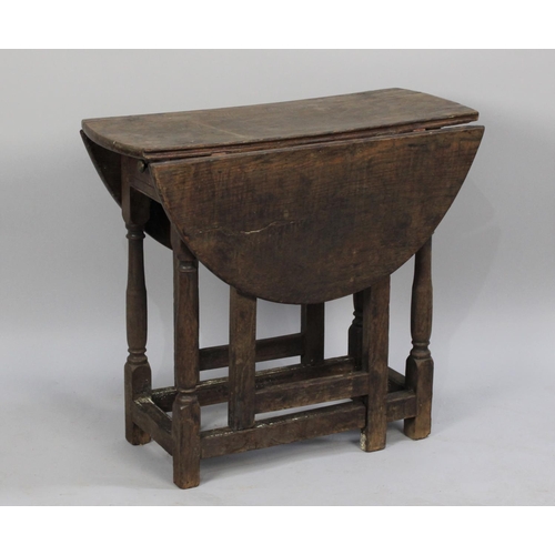 337 - A Small 19th Century Oak Drop Leaf Oval Topped Gate Leg Table of Rustic Type, 75cms Wide