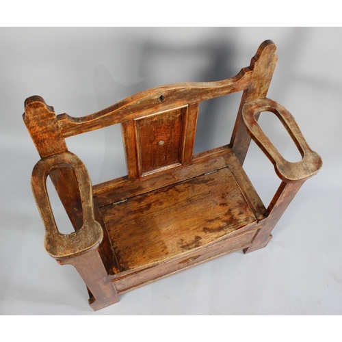 39 - A Mid 20th Century Oak Hall Seat with hinged Lid to Box Store and Side Stick Stands, 84cms Wide