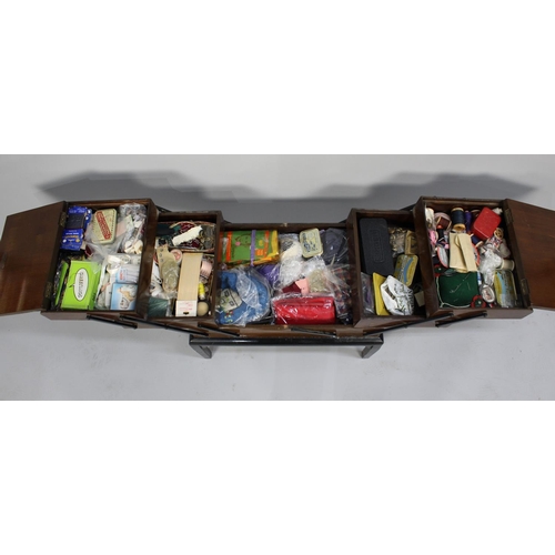 51 - A Mid 20th Century Walnut Cantilevered Sewing Box with Contents, 54cms Wide