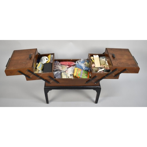 51 - A Mid 20th Century Walnut Cantilevered Sewing Box with Contents, 54cms Wide