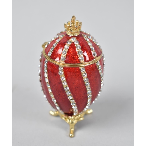 8 - A Novelty Jewelled and Enamel Box in the Form of a Russian Egg on Tripod Scrolled Feet, 7.5cms High