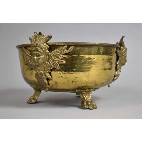 101 - A Beaten Brass Circular Bowl in the French Style with Maiden Mounts and Claw Feet, 26cm Diameter